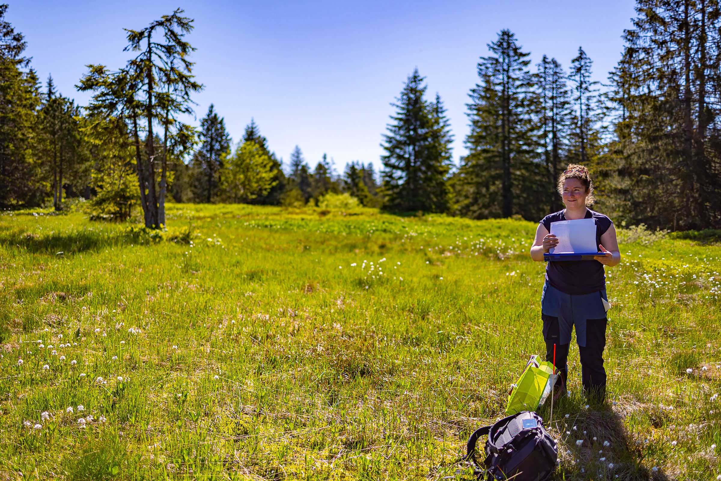 Researcher with her documents on a meadow.