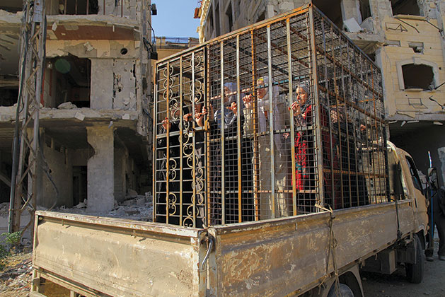 Supporters of Bashar al-Assad locked in cages 