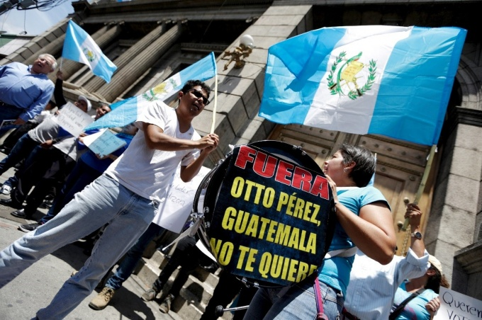 Demonstrators yell slogans outside the Guatemalan Congress