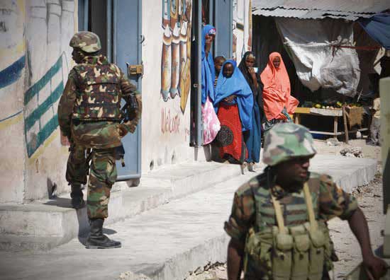 Somali women looking at AMISOM soldiers