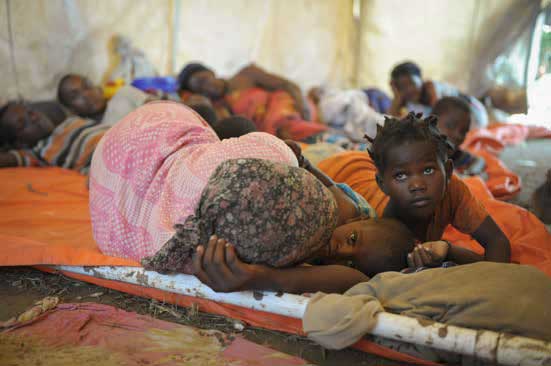Women and children in November 2013 sleep in a makeshift hospital erected at an AMISOM military camp