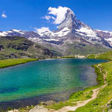 blaugrüner Bergsee mit Berg im Hintergrund