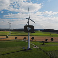 two wind turbines on fields