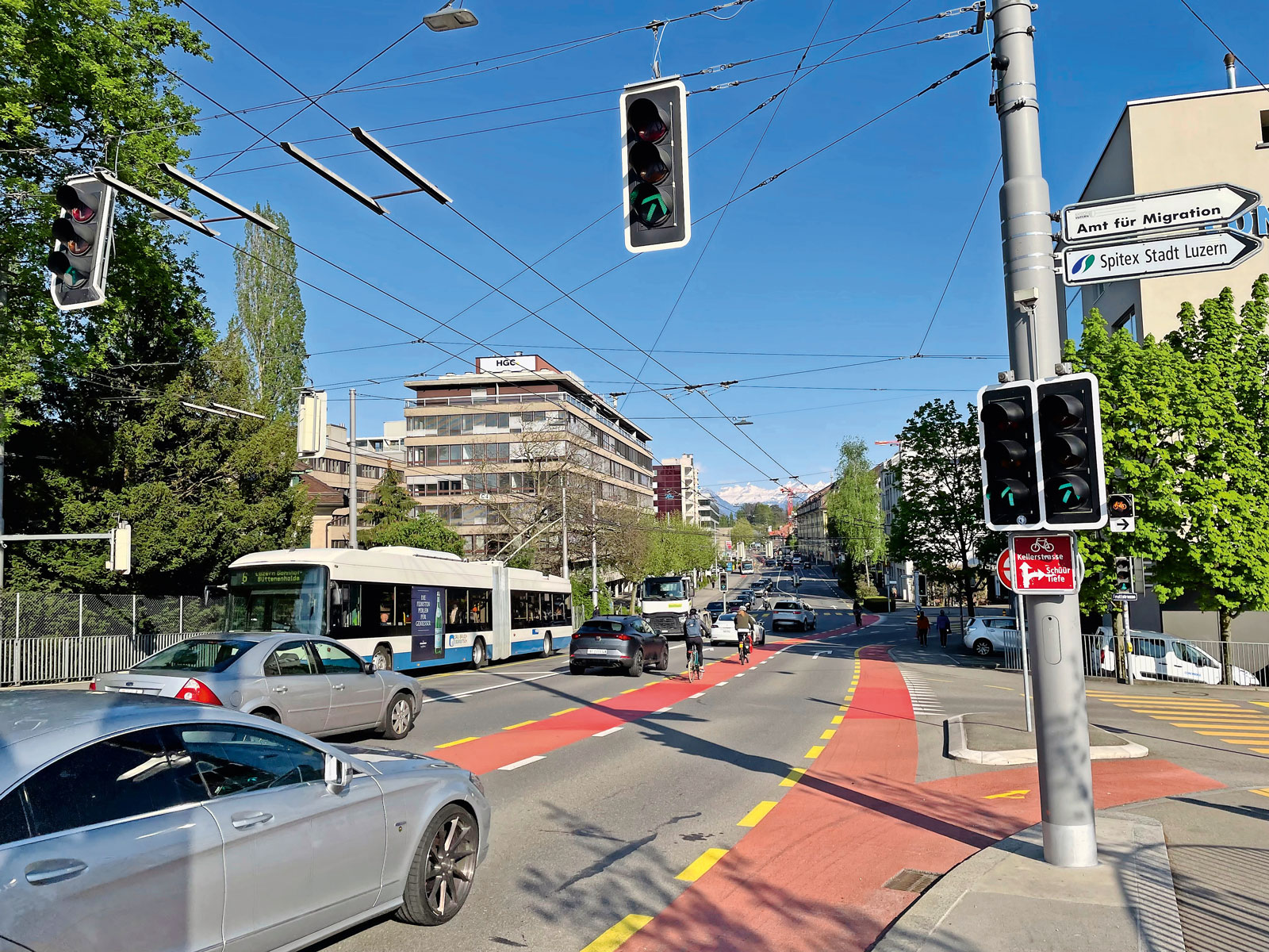 road junction with traffic lights, cyclists, bus and cars