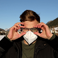 man wearing glasses and a face mask