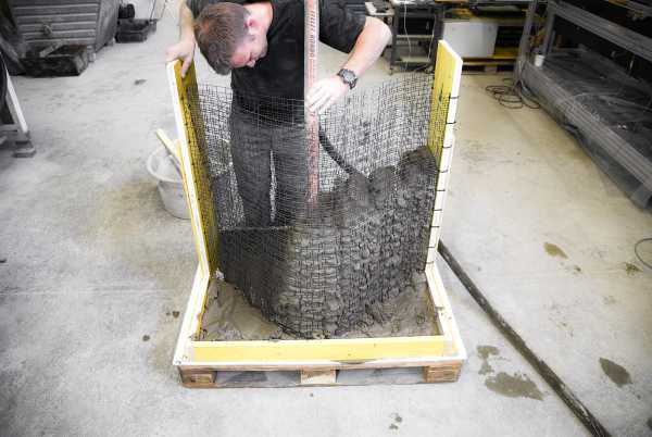 A Mesh Mould prototype grid is filled with concrete.