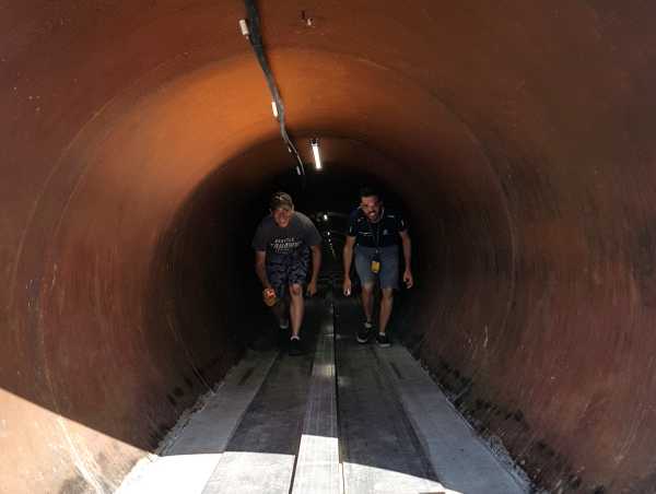 Enlarged view: team members of Swissloop in the pipe