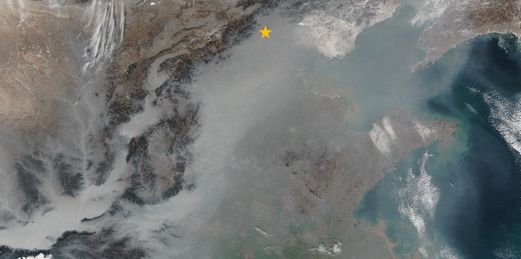 Milky, gray smog shrouds many of the valleys and lowlands of eastern China in January 2017. The orange star marks the location of Beijing . (Photograph: Nasa Earth Observatory)