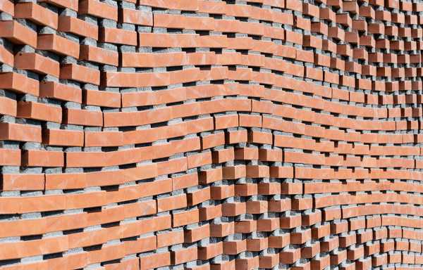 A brick wall with a wavelike structure.