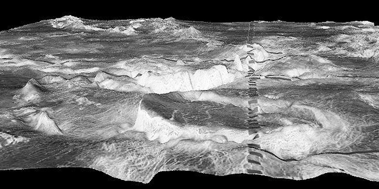 The circular mountain in the foreground is a 500 kilometre corona in the Galindo region of Venus. The dark rectangles are an artifact. (Picture: NASA/JPL/USGS)