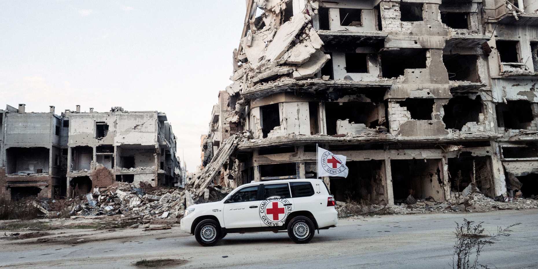 ICRC car in front of demolished building