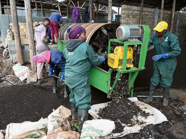 Compost is being prepared with a sifter