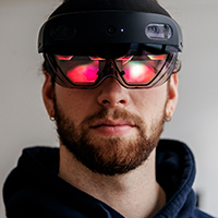 Lukas Roder wears AR glasses and operates the virtual programme with his finger