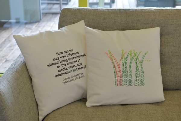 Two cushions with universal questions printed on them.