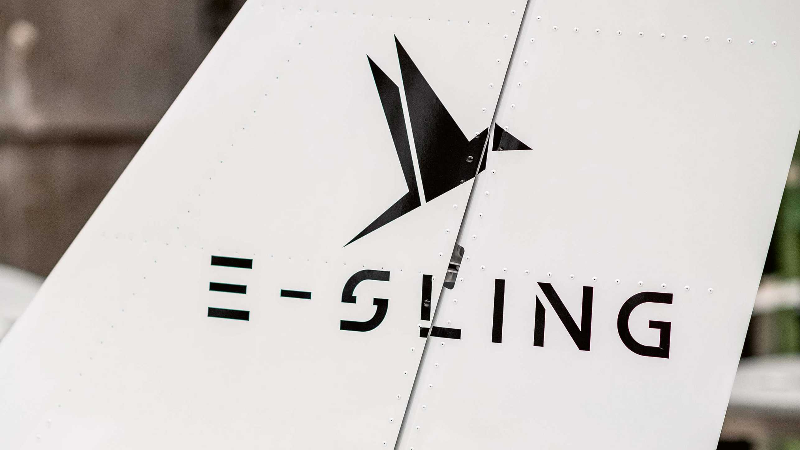 E-Sling logo with paper crane on the tail fin of the aircraft