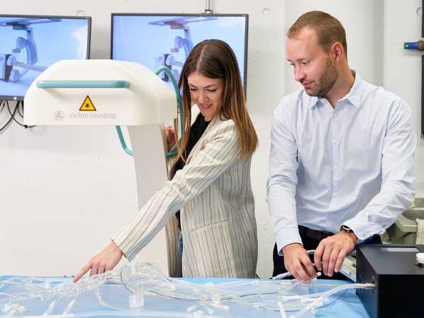 Christophe Chautems and Silvia Viviani look at the catheter, which can be controlled magnetically.