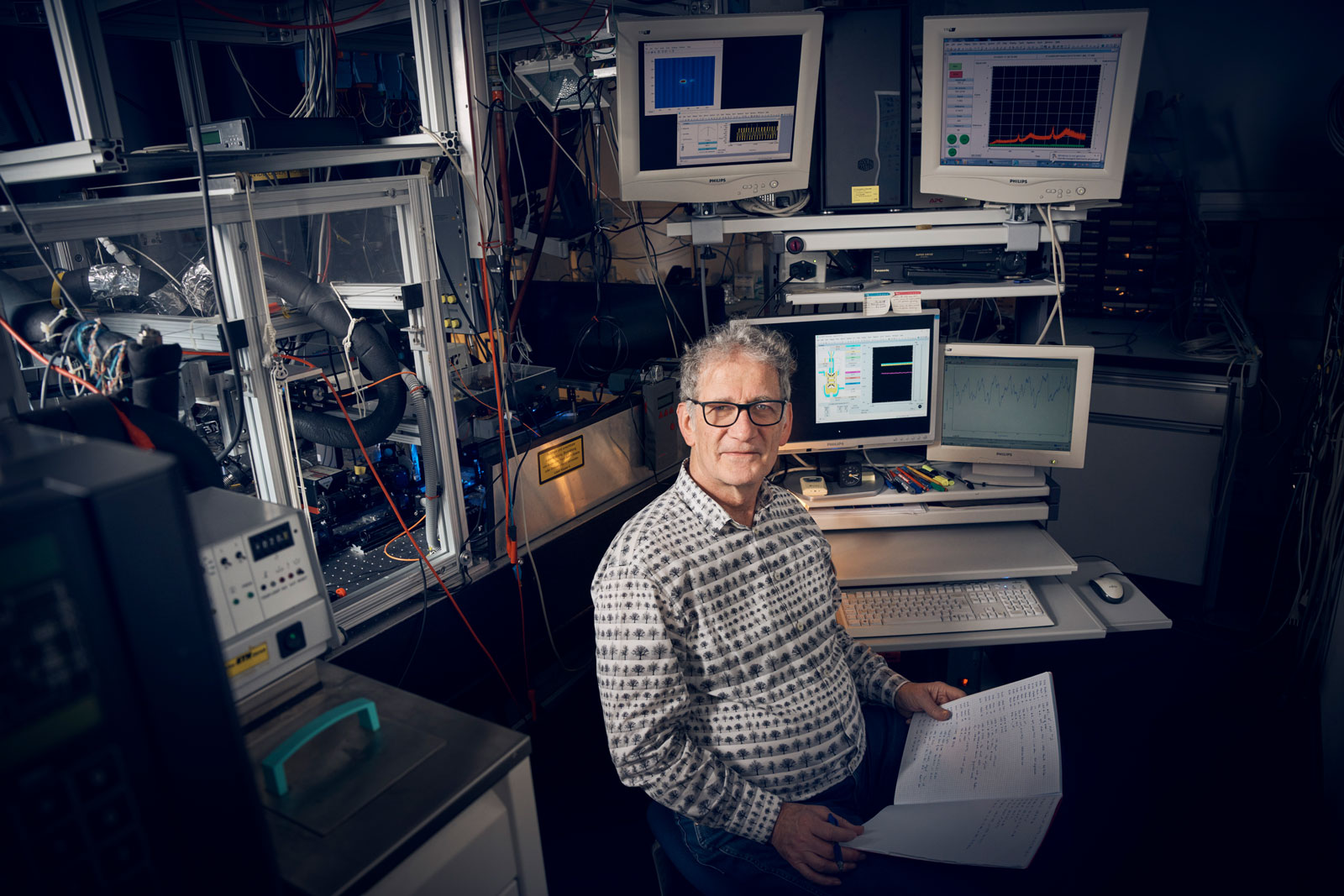 Tom Peter in his lab, surrounded by monitors and measuring devices