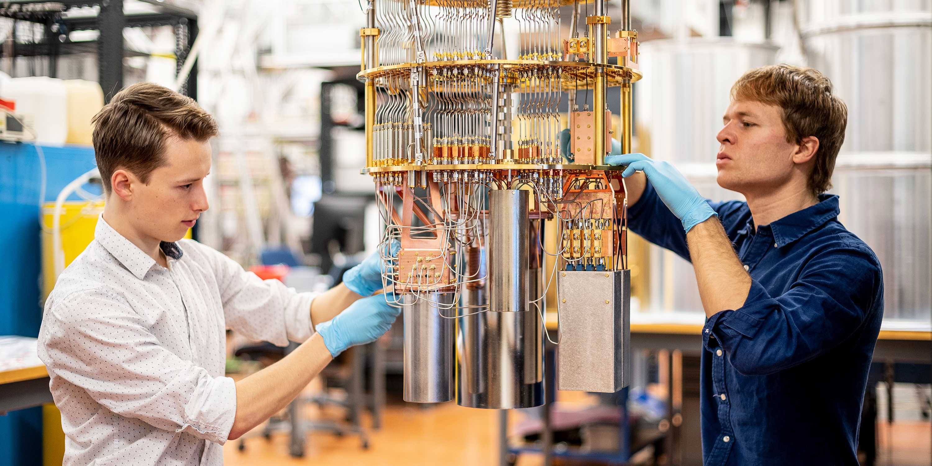 Two people working on the signal lines of the quantum chips.