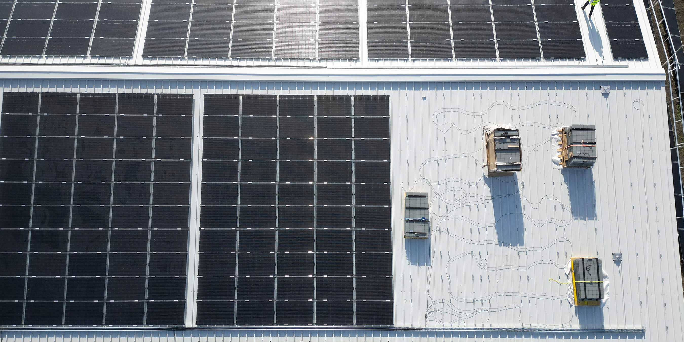 Bird's eye view of solar cells on a roof.