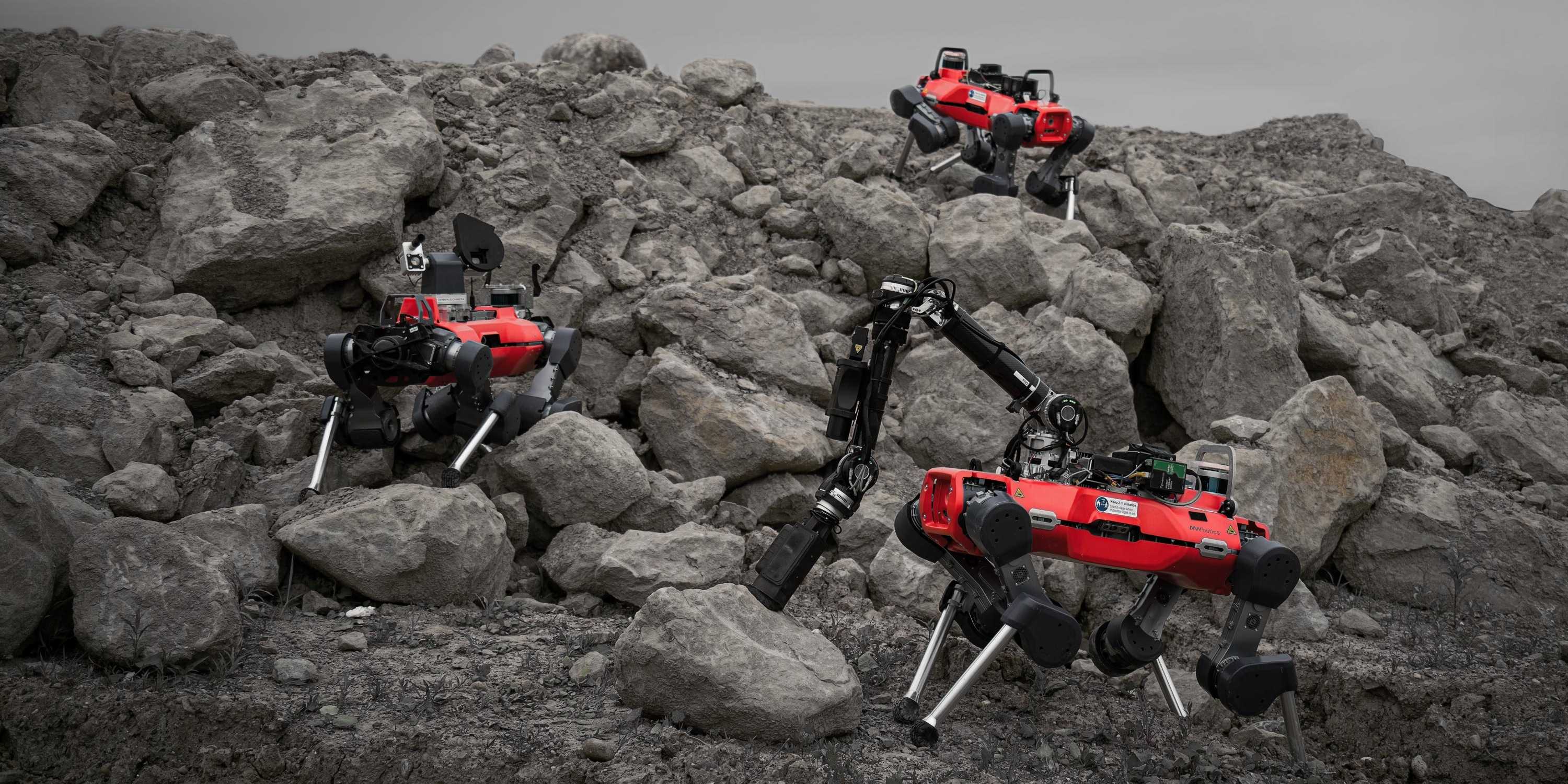 Three legged robots (red) in a stony landscape (gravel quarry).