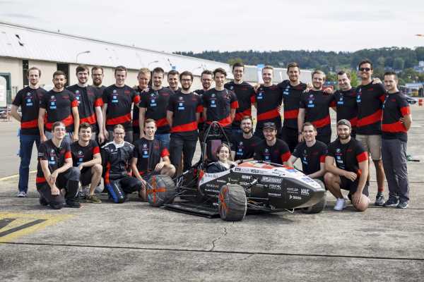 Team photo of AMZ. The electric race car can be seen in the front center.