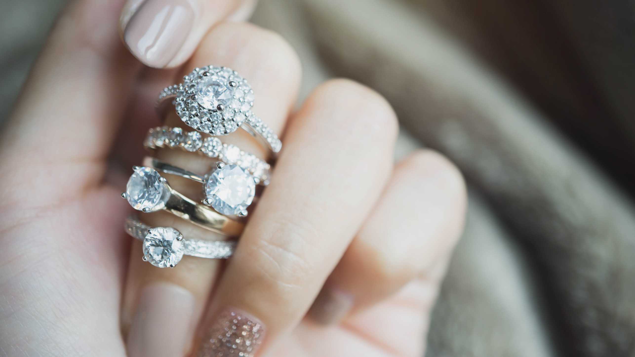 Enlarged view: A woman's hand with many diamond rings