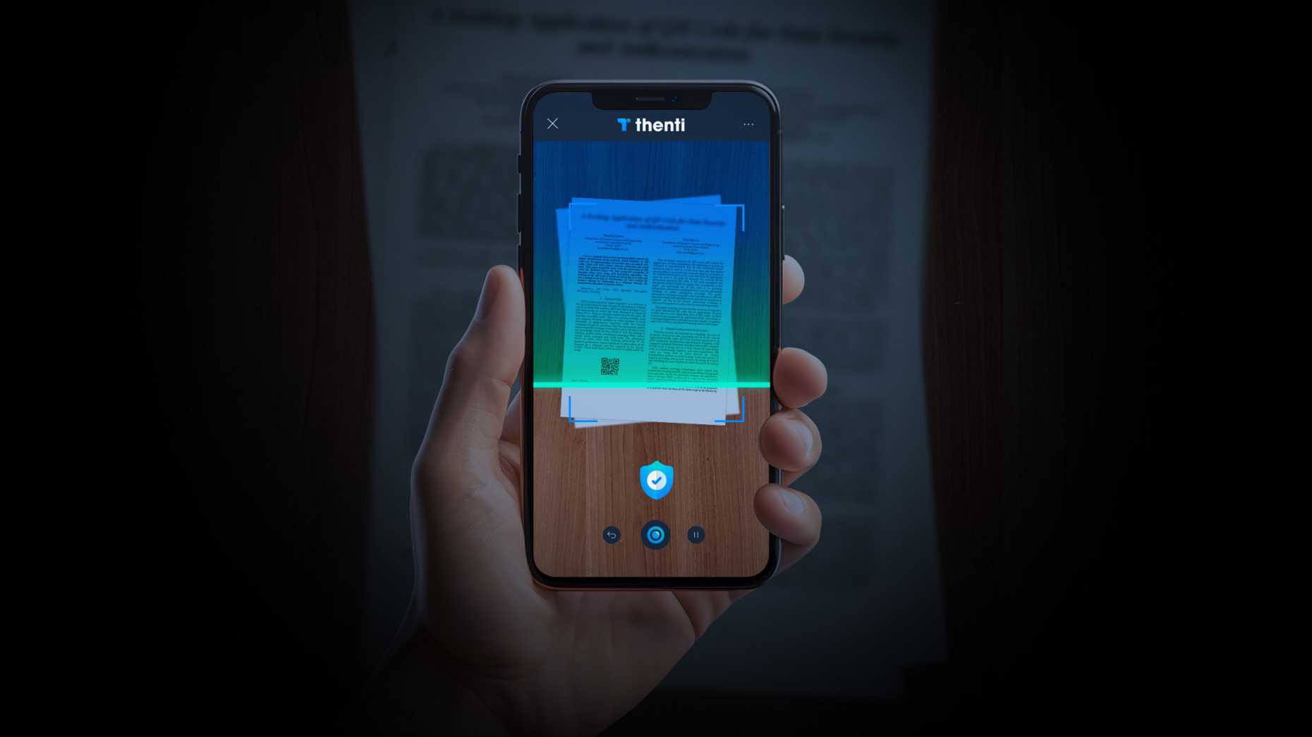 A document is scanned with the smartphone using the thenti app.