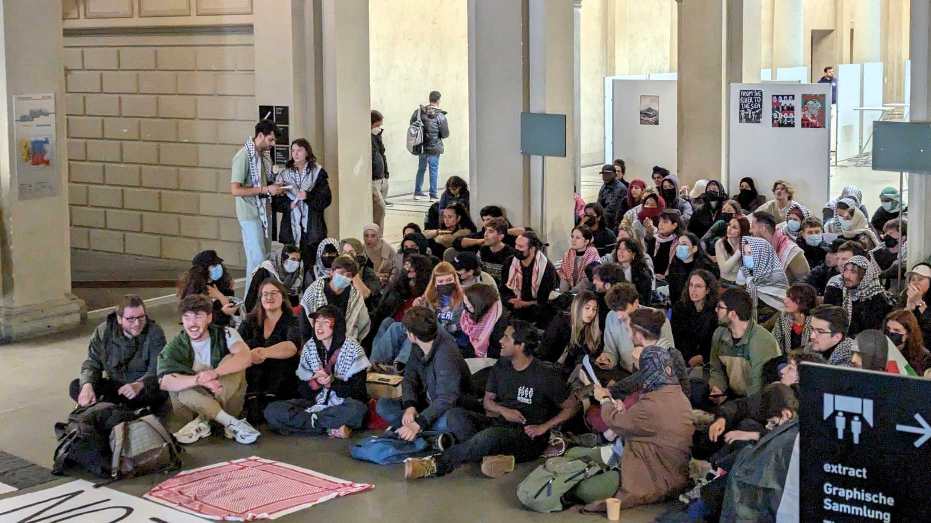 Protesters sitting and standing in the main hall of ETH Zurich on 7 May 2024