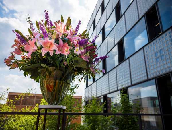 A large, colorful bouquet of flowers in front of the building.