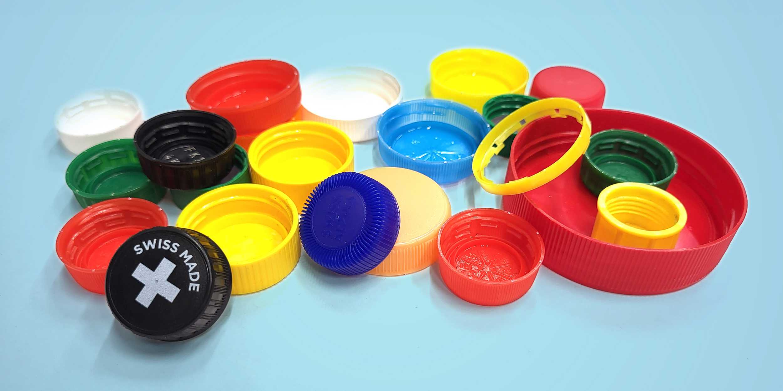 A pile of colorful bottle caps from plastic bottles