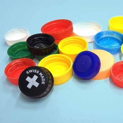 A pile of colorful bottle caps from plastic bottles