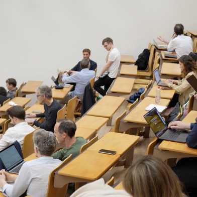 Participants sit in a lecture hall