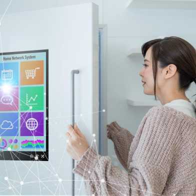 A woman opens a smart fridge