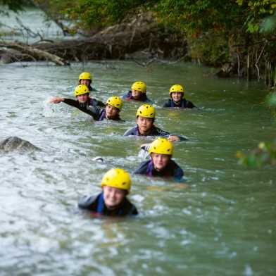 Students swim through the river