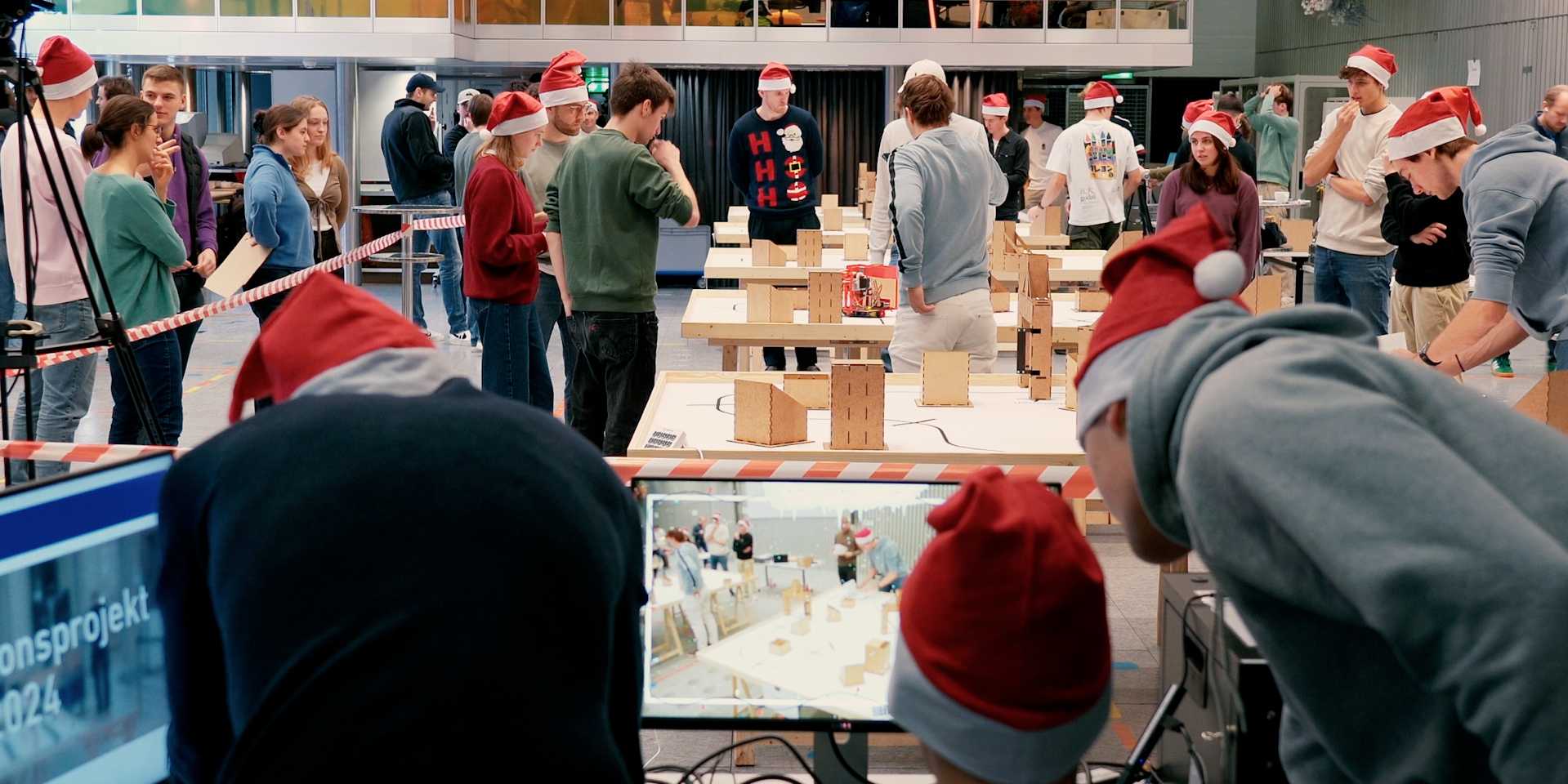 Mechanical engineering students test their innovation projects and wear Christmas hats.