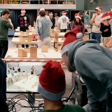 Mechanical engineering students test their innovation projects and wear Christmas hats.