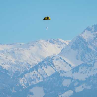 The test satellite is in the air in front of a mountain range