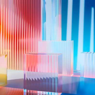 Bright colourful abstract background made of transparent and ribbed acrylic glass, which is illuminated by coloured light