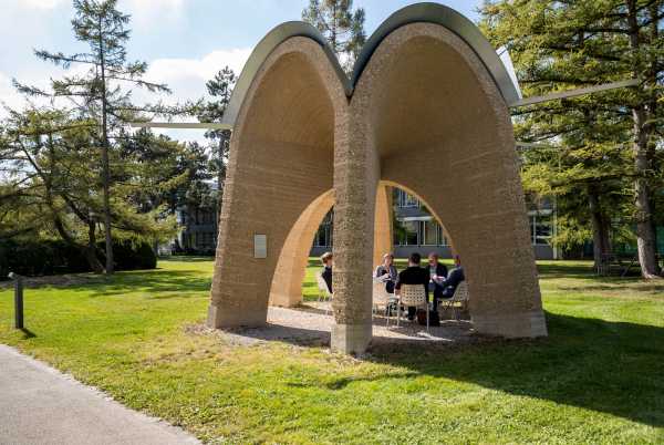 students sitting under an arch