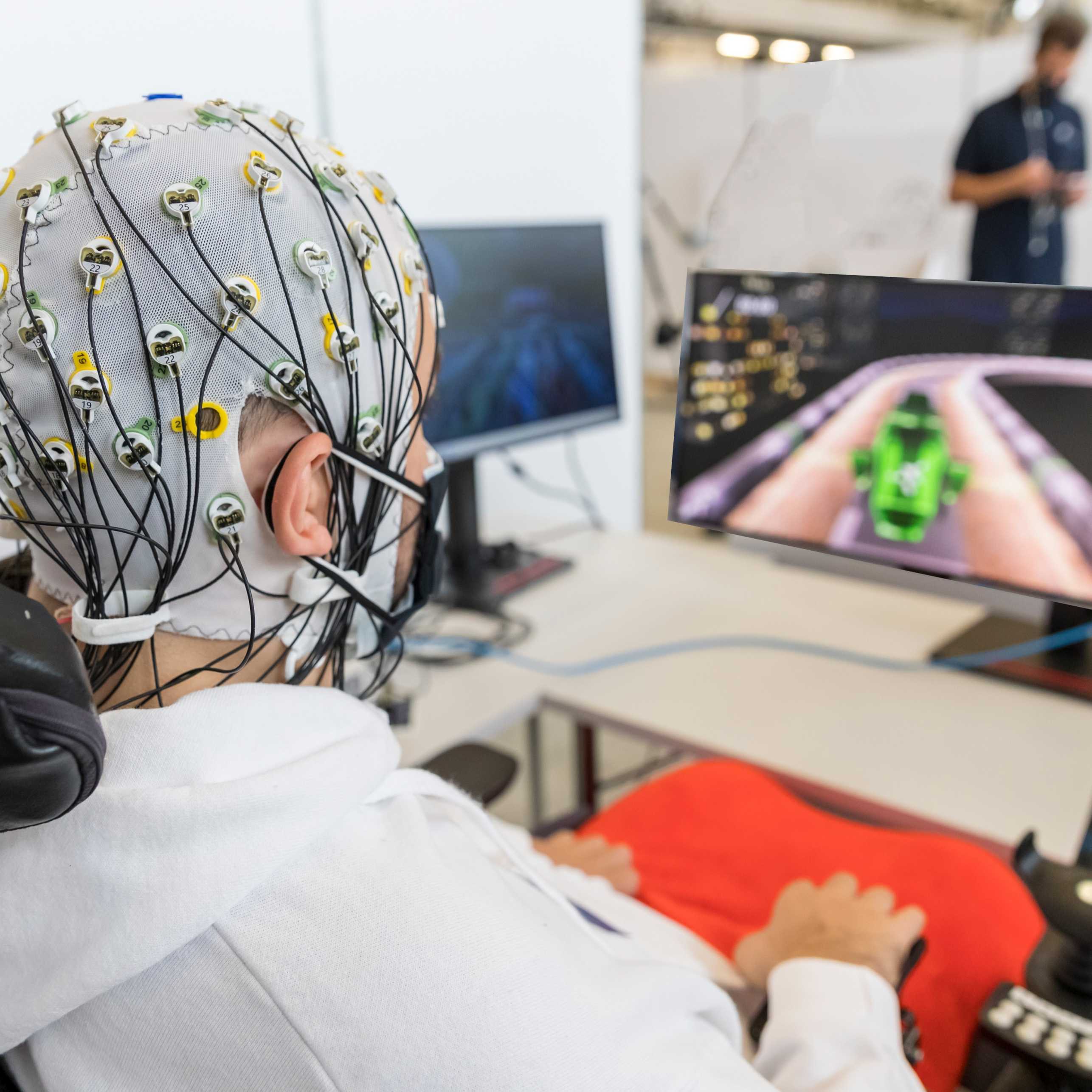 Scholar seen from the back wearing a Brain Comuter Interface (BCI) headset while playing a video game.