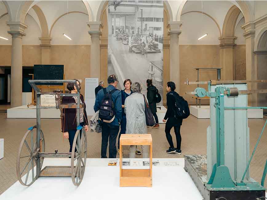 Insight into the exhibition with various objects such as a welder's trolley.