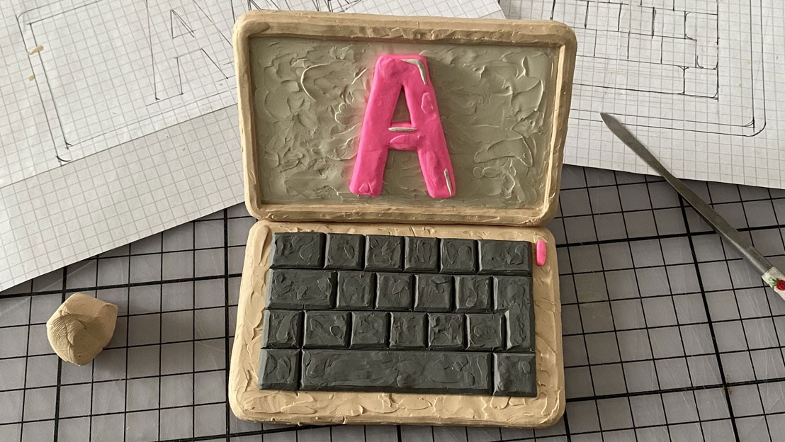 A Laptop made from plasticine with an extra large letter "A" on the screen.