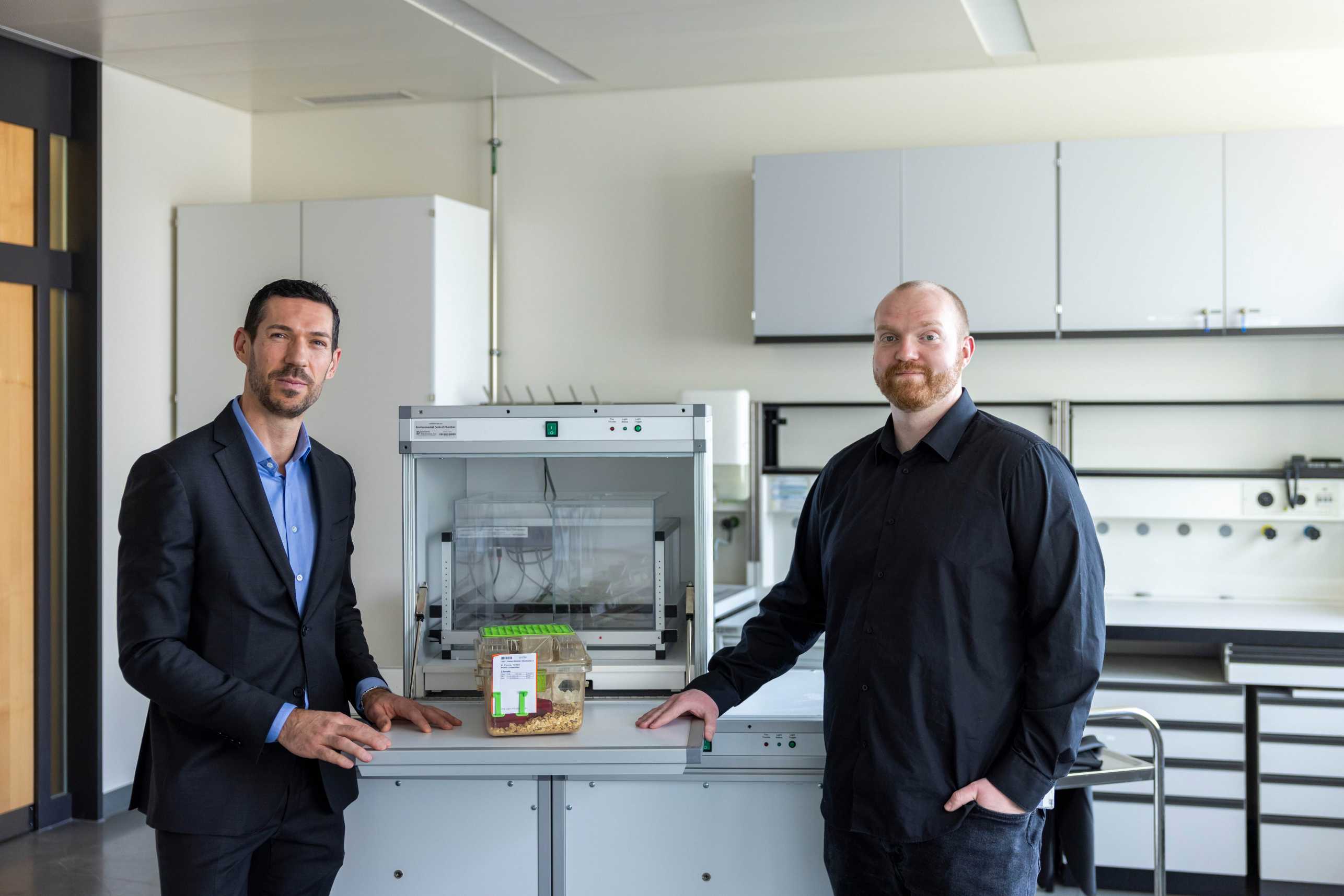 Johannes Bohacek (left) and Oliver Sturman (right) stand in the lab