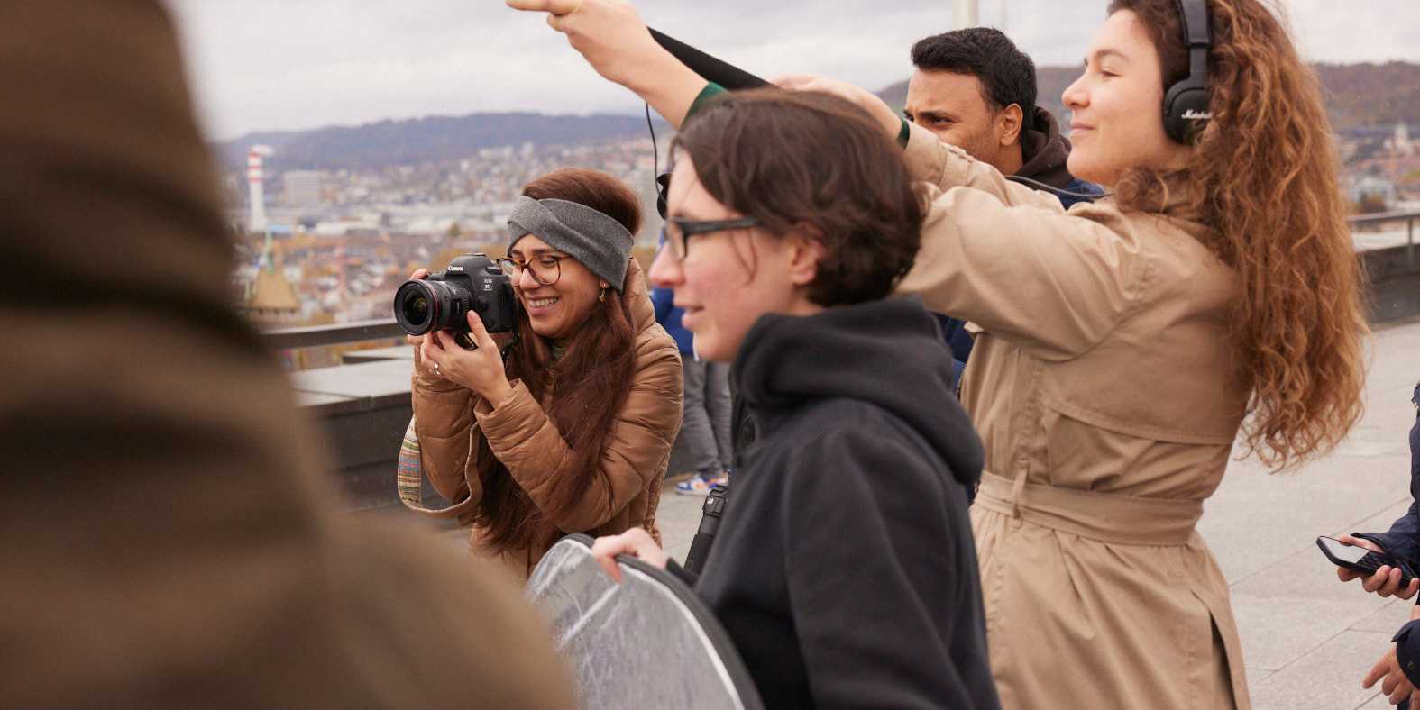 Course participants filming, one woman holds the camera, another the microphone